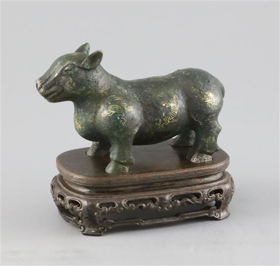 A Chinese gold and silver inlaid bronze figure of a tapir, Han dynasty or later, L. 12cm, excluding hardwood stand and fitted box